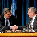 UN Photo/Evan Schneider: Alain Le Roy (left) and Yury Fedotov shake hands after signing pact to fight organized crime in conflict areas