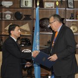 UNWTO Secretary-General, Taleb Rifai (left), and UNODC Executive Director, Yury Fedotov (right) at the signing of a new Cooperation Agreement between the two organizations.