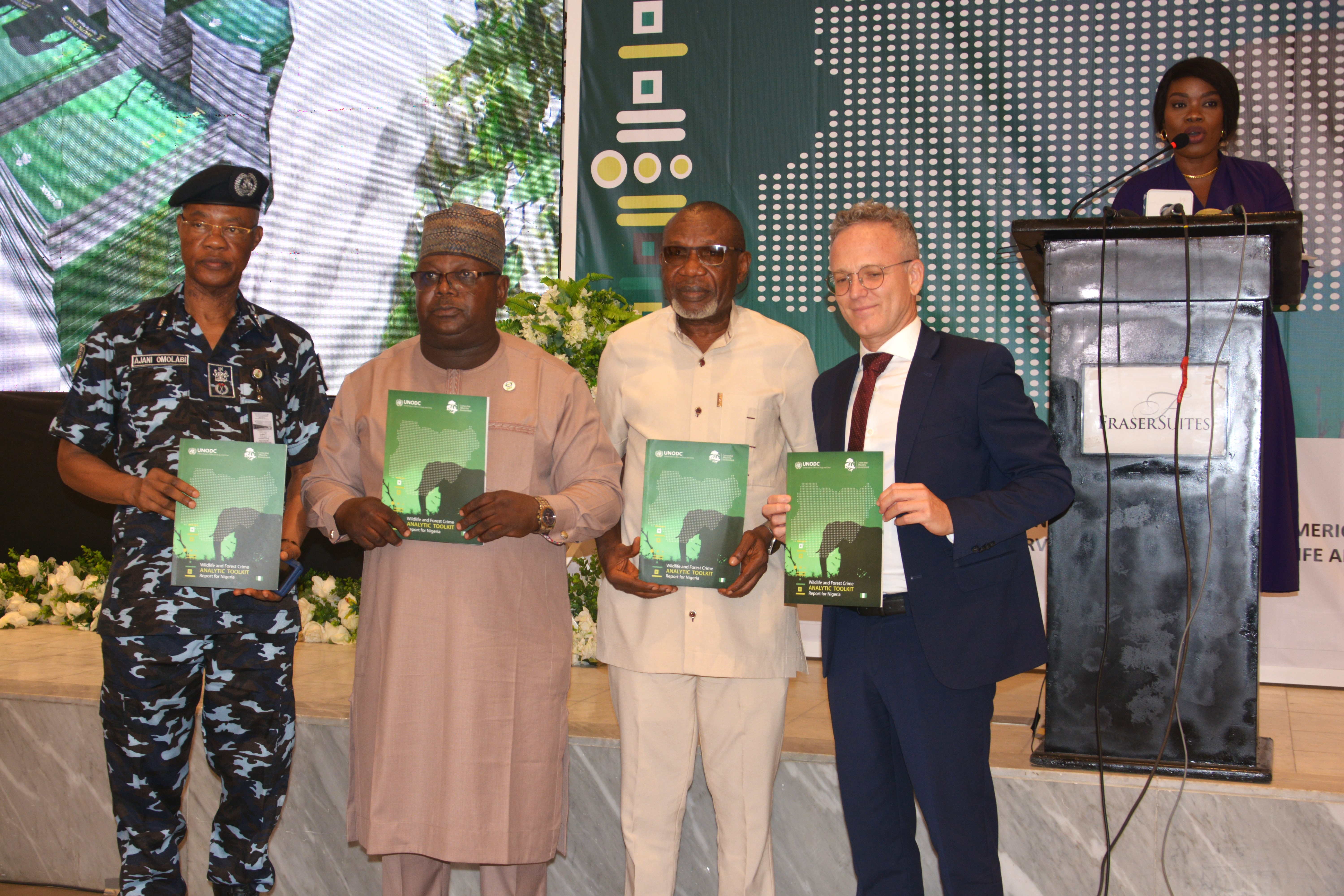 Stakeholders at the launch of the ICCWC toolkit report in Nigeria hold up a copy of the report