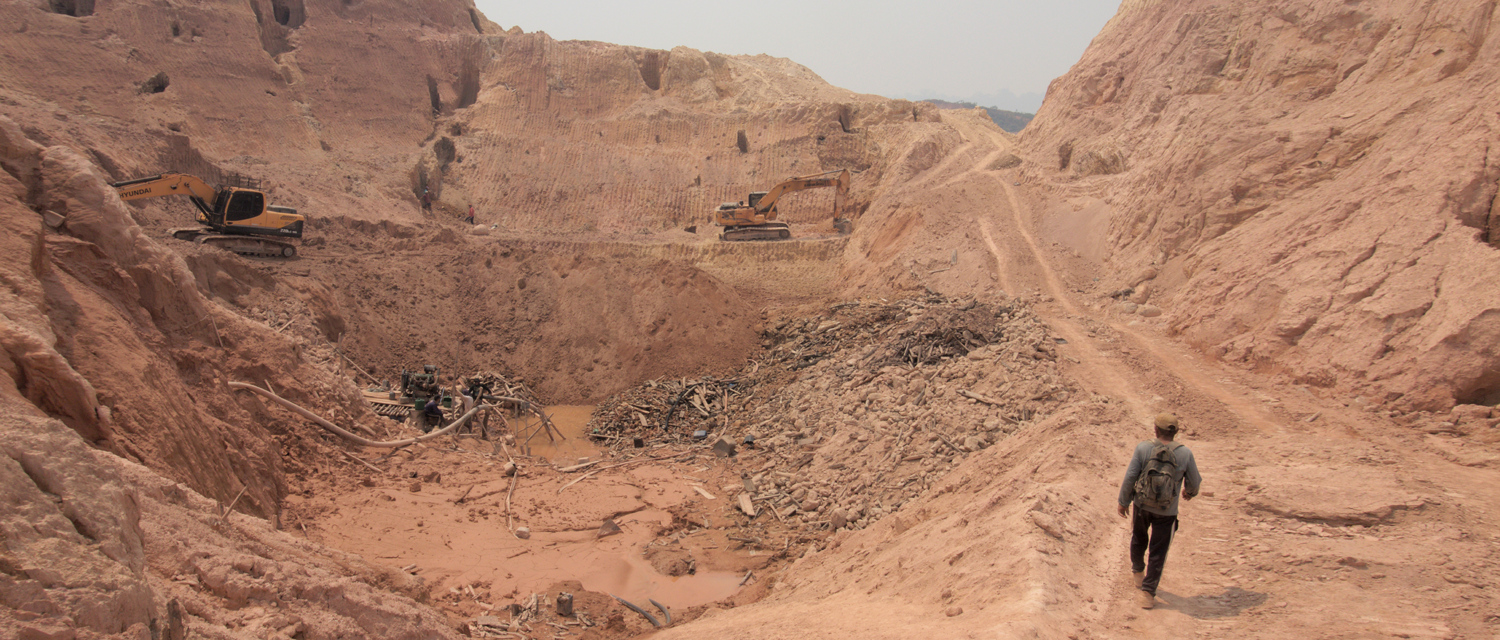 Gold mining site, diggers and a worker